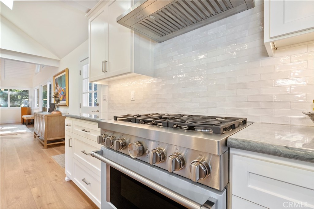 1545 Willow Creek Road Paso Robles, CA 93446 - Photo 15 of 52 Elegant tile backsplash showcased within a clean, sophisticated color palette that enhances the kitchen’s timeless design.