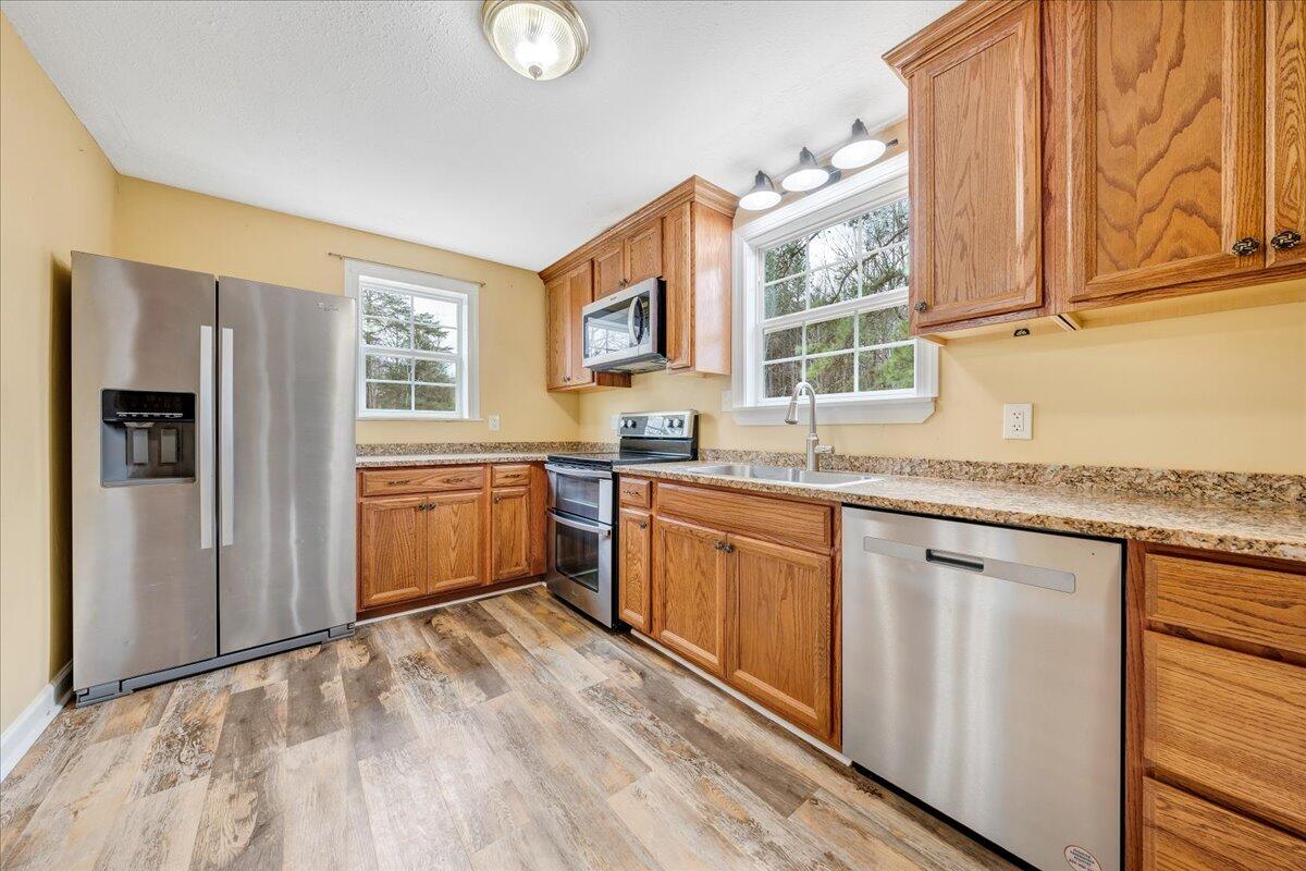 5398 Goodview Road Goodview, VA 24095 - Photo 12 of 59 a kitchen with granite countertop a sink stainless steel appliances and cabinets
