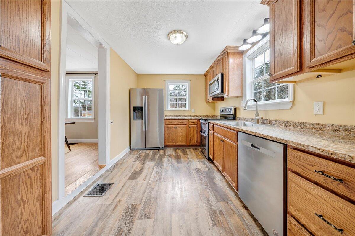 5398 Goodview Road Goodview, VA 24095 - Photo 14 of 59 a large kitchen with granite countertop a large counter top space a sink stainless steel appliances and cabinets