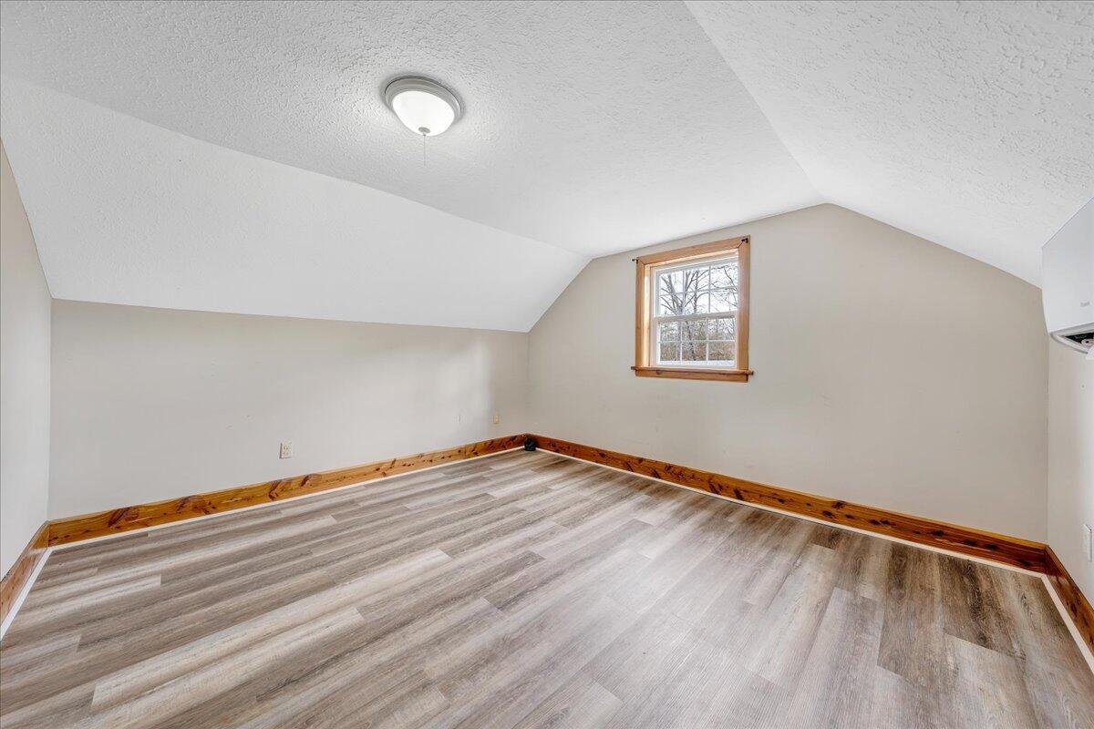5398 Goodview Road Goodview, VA 24095 - Photo 22 of 59 a view of an empty room with wooden floor and a window