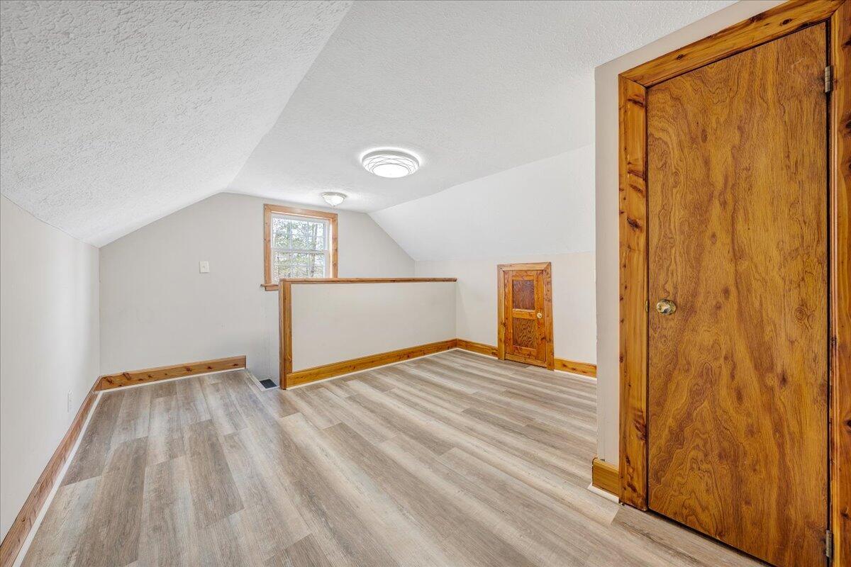 5398 Goodview Road Goodview, VA 24095 - Photo 23 of 59 a view of an empty room with wooden floor and a window