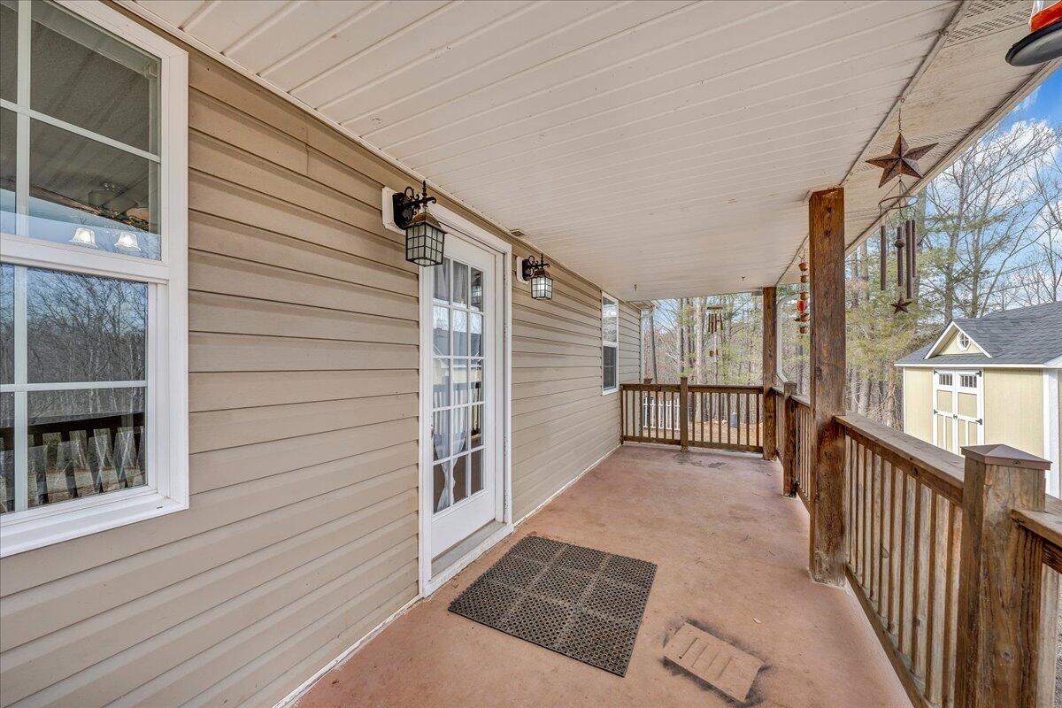 5398 Goodview Road Goodview, VA 24095 - Photo 28 of 59 a view of a porch with wooden floor and stairs
