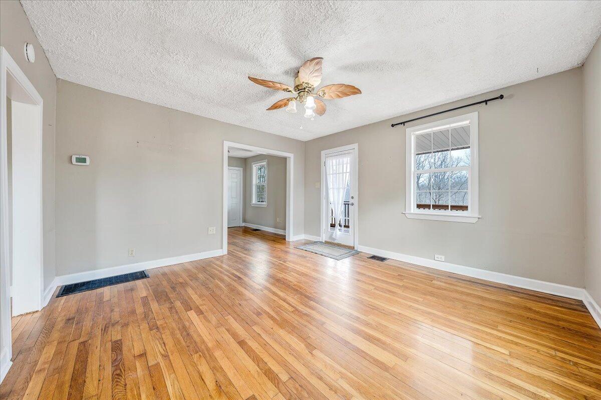 5398 Goodview Road Goodview, VA 24095 - Photo 3 of 59 a view of an empty room with window and wooden floor