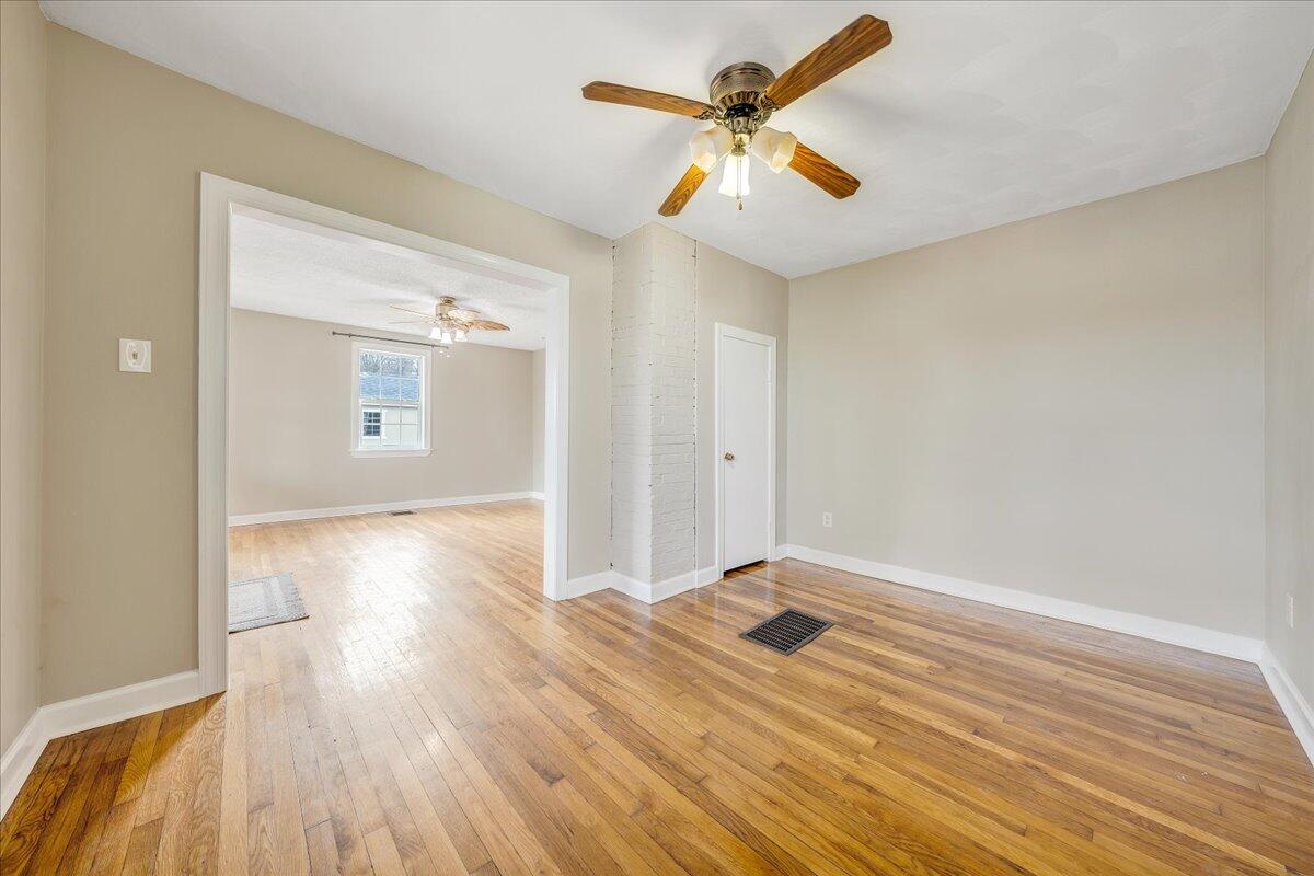 5398 Goodview Road Goodview, VA 24095 - Photo 7 of 59 a view of a livingroom with wooden floor and a ceiling fan