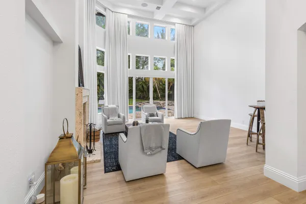 a dining room with furniture potted plants and wooden floor