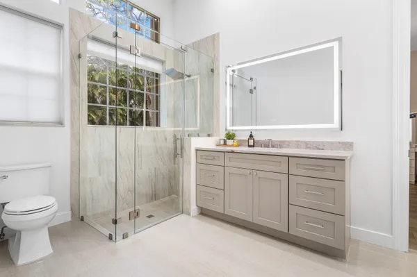 a bathroom with a toilet a sink and mirror