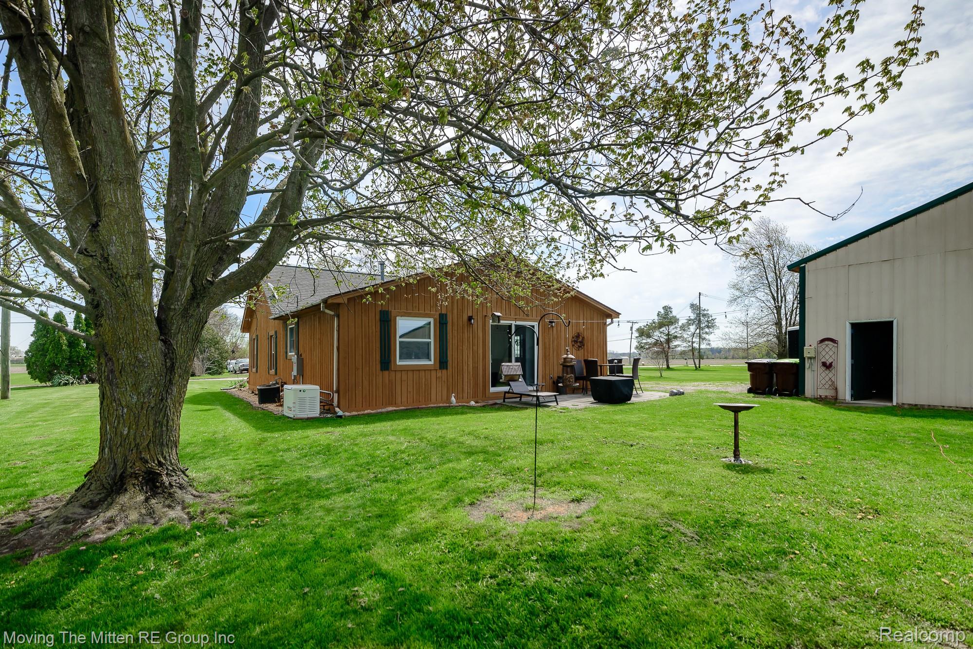 9260 Pitman Road Ypsilanti, MI 48197 - Photo 29 of 45 Rear view of property featuring a lawn and a patio