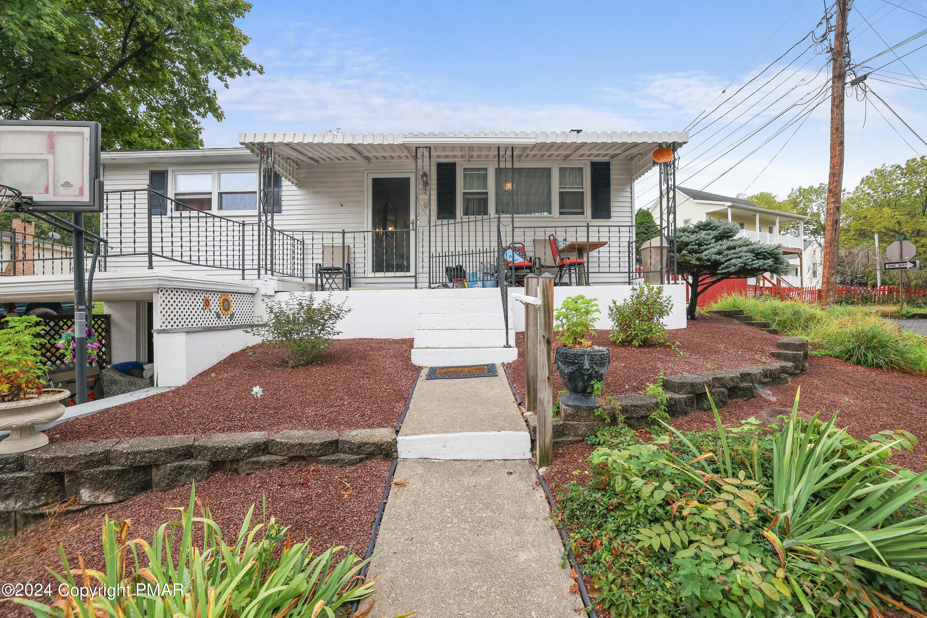9 Jewel Street Roseto, PA 18013 - Photo 1 of 23 a view of a patio with table and chairs potted plants and floor to ceiling window