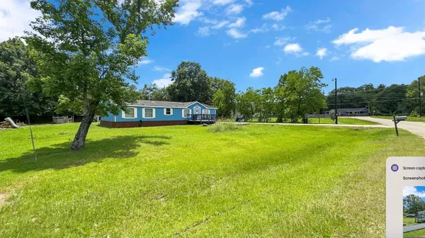 a view of a house with a backyard