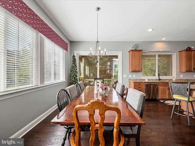 a kitchen with a refrigerator a sink and wooden cabinets