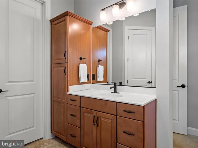 a living room with furniture a flat screen tv and a lamp