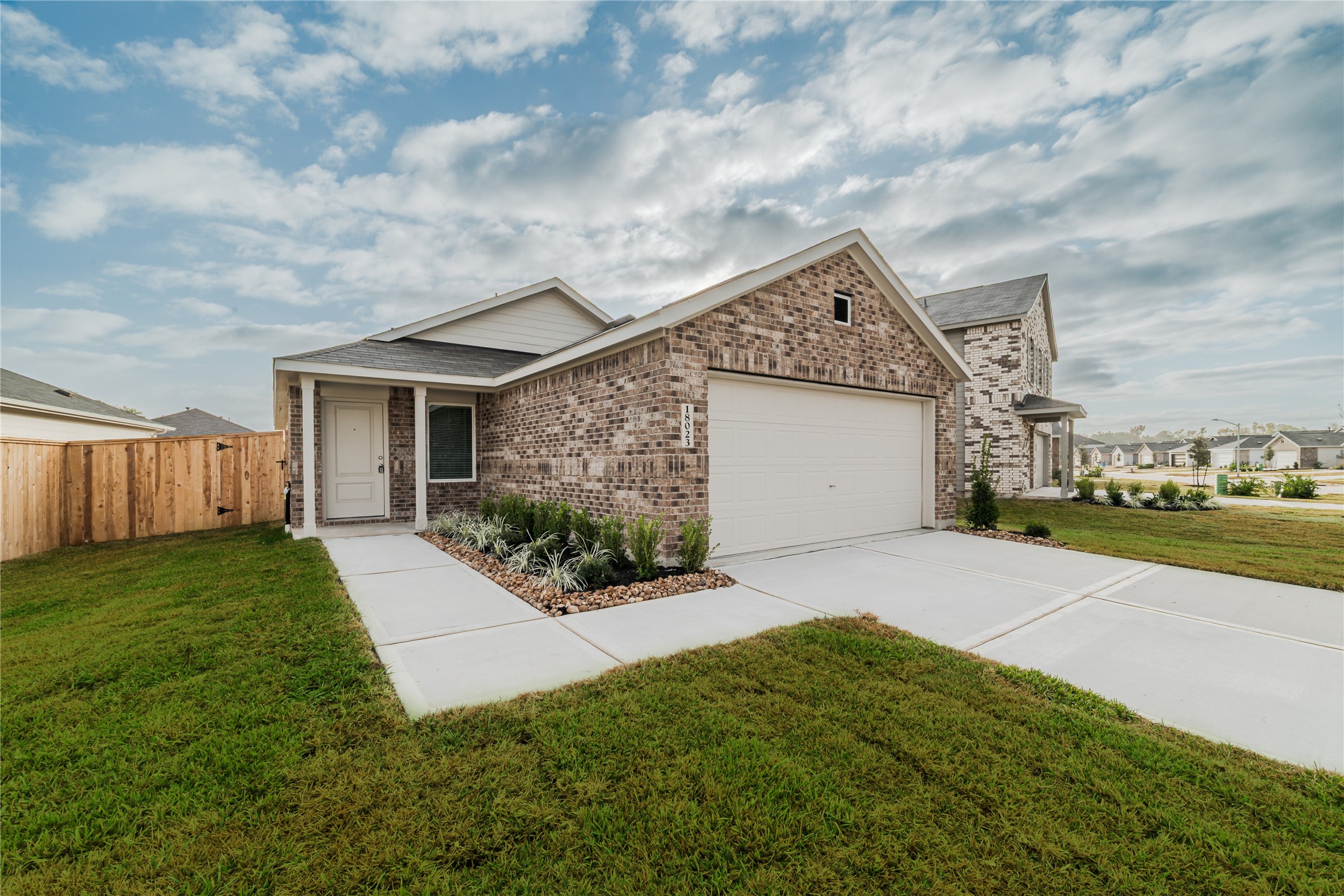 18023 Trepito Avenue New Caney, TX 77357 - Photo 1 of 20 a front view of a house with a yard and garage