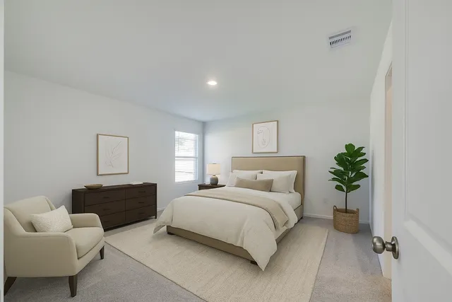 a bedroom with a bed and a couch