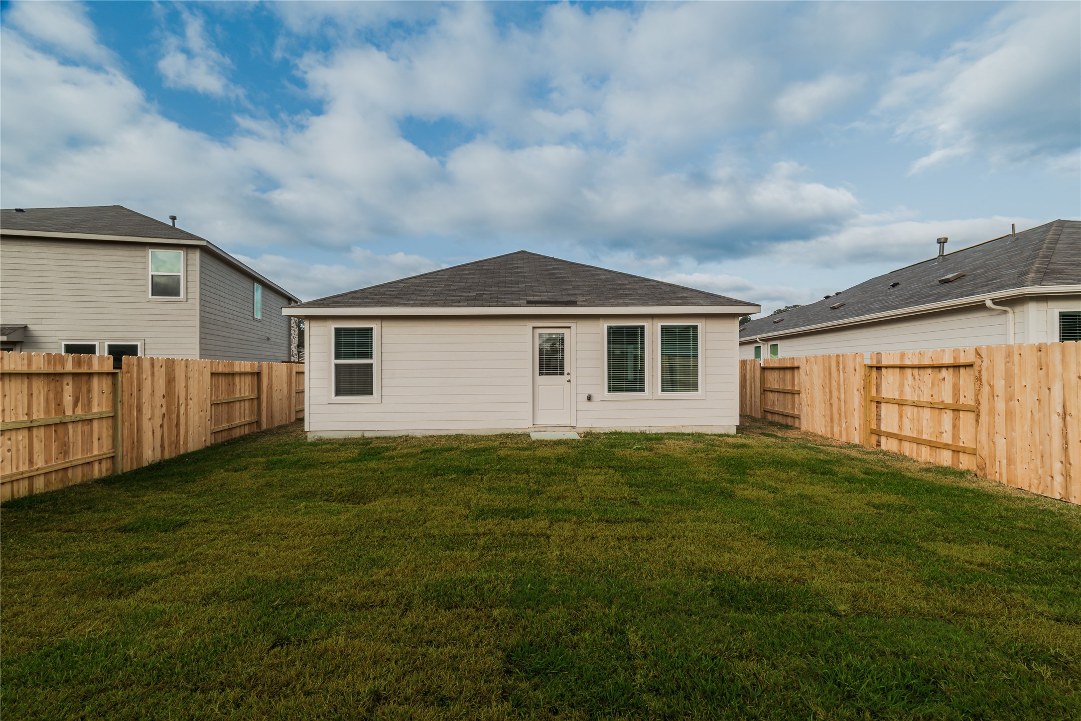 18023 Trepito Avenue New Caney, TX 77357 - Photo 18 of 20 a backyard of a house with lots of green space