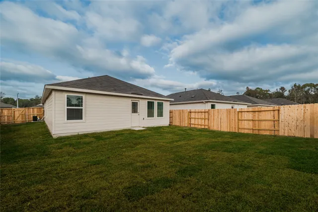a backyard of a house with table and chairs