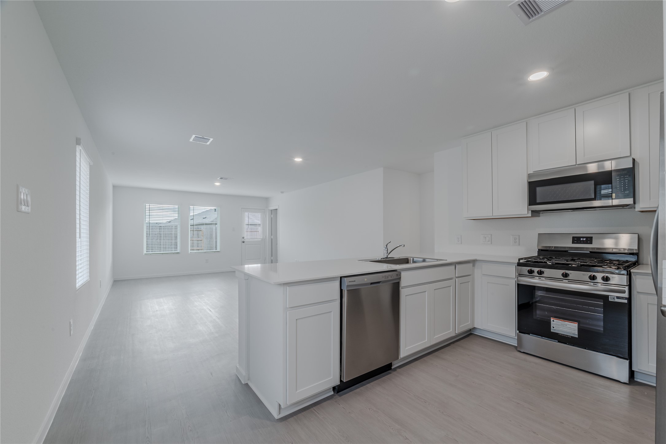 18023 Trepito Avenue New Caney, TX 77357 - Photo 5 of 20 a kitchen with stainless steel appliances granite countertop a stove and a sink
