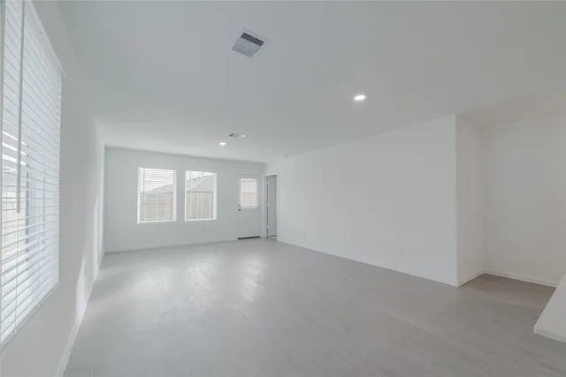 an empty room with windows and entrance