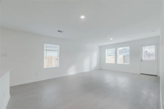 an empty room with a empty space and windows