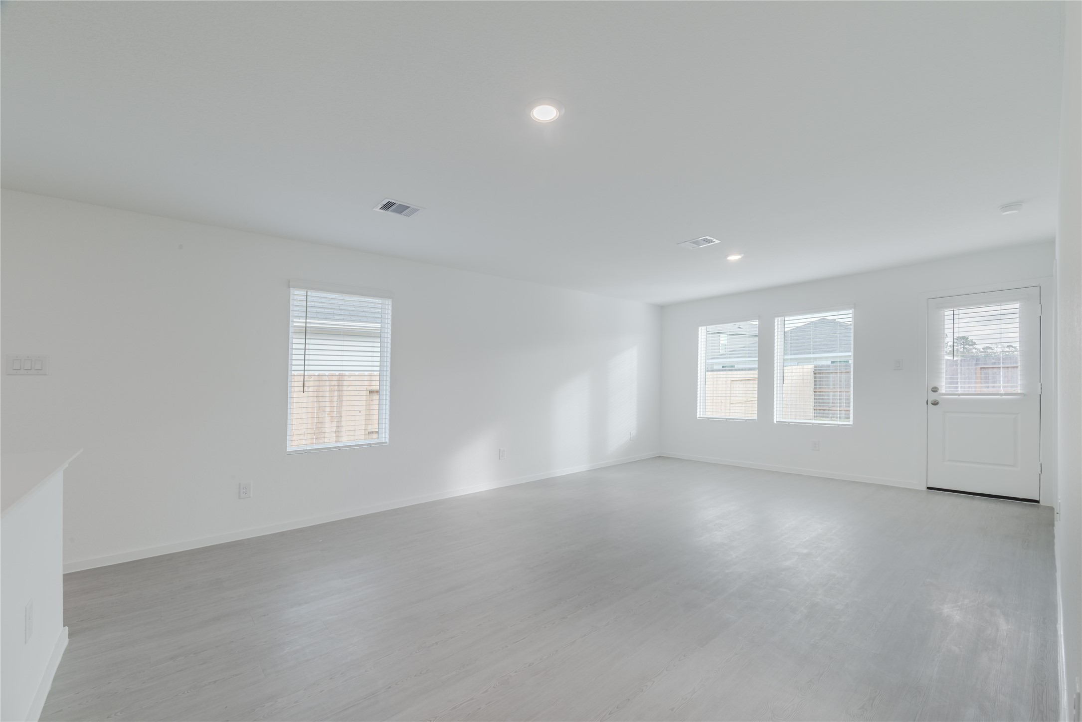 18023 Trepito Avenue New Caney, TX 77357 - Photo 9 of 20 an empty room with a empty space and windows