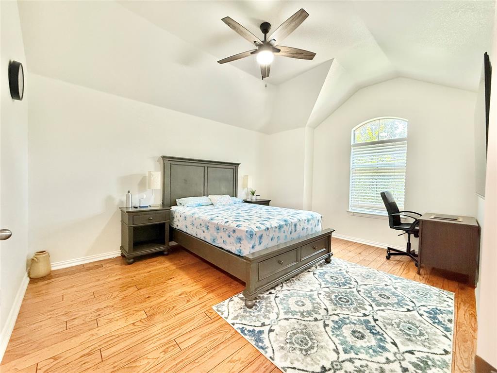 2754 Ridge View Road Frisco, TX 75034 - Photo 19 of 34 a bedroom with a bed and a table in it
