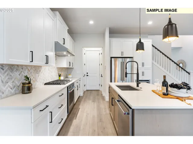 a kitchen with granite countertop white cabinets and white appliances