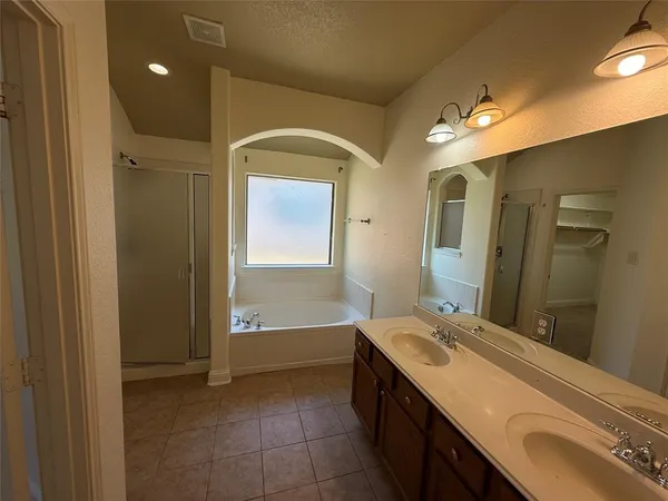 a bathroom with a double vanity sink and a mirror