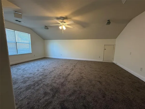 a view of a room with wooden floor and chandelier