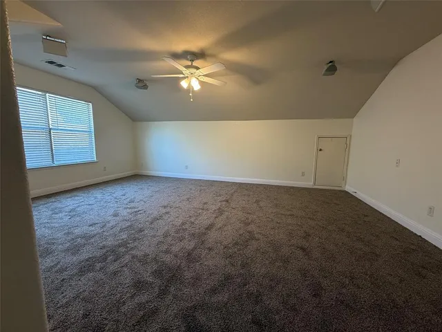 a view of a room with wooden floor and chandelier