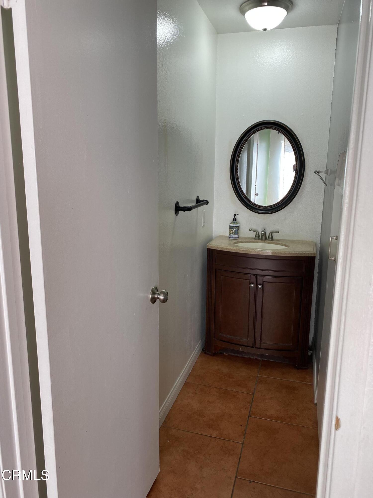 5305 Perkins Road Oxnard, CA 93033 - Photo 12 of 23 a bathroom with a mirror and a sink