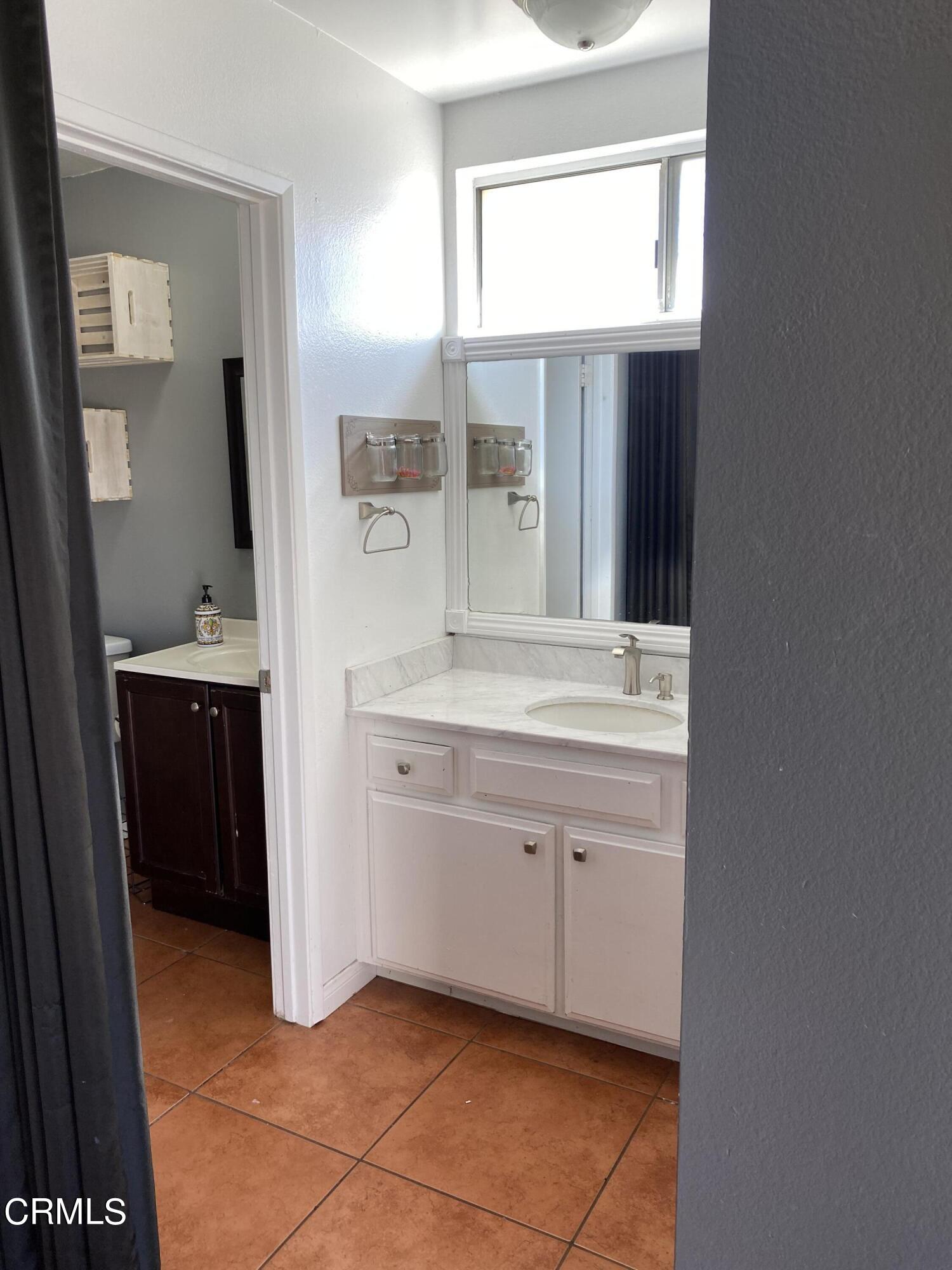5305 Perkins Road Oxnard, CA 93033 - Photo 15 of 23 a bathroom with a sink vanity and mirror