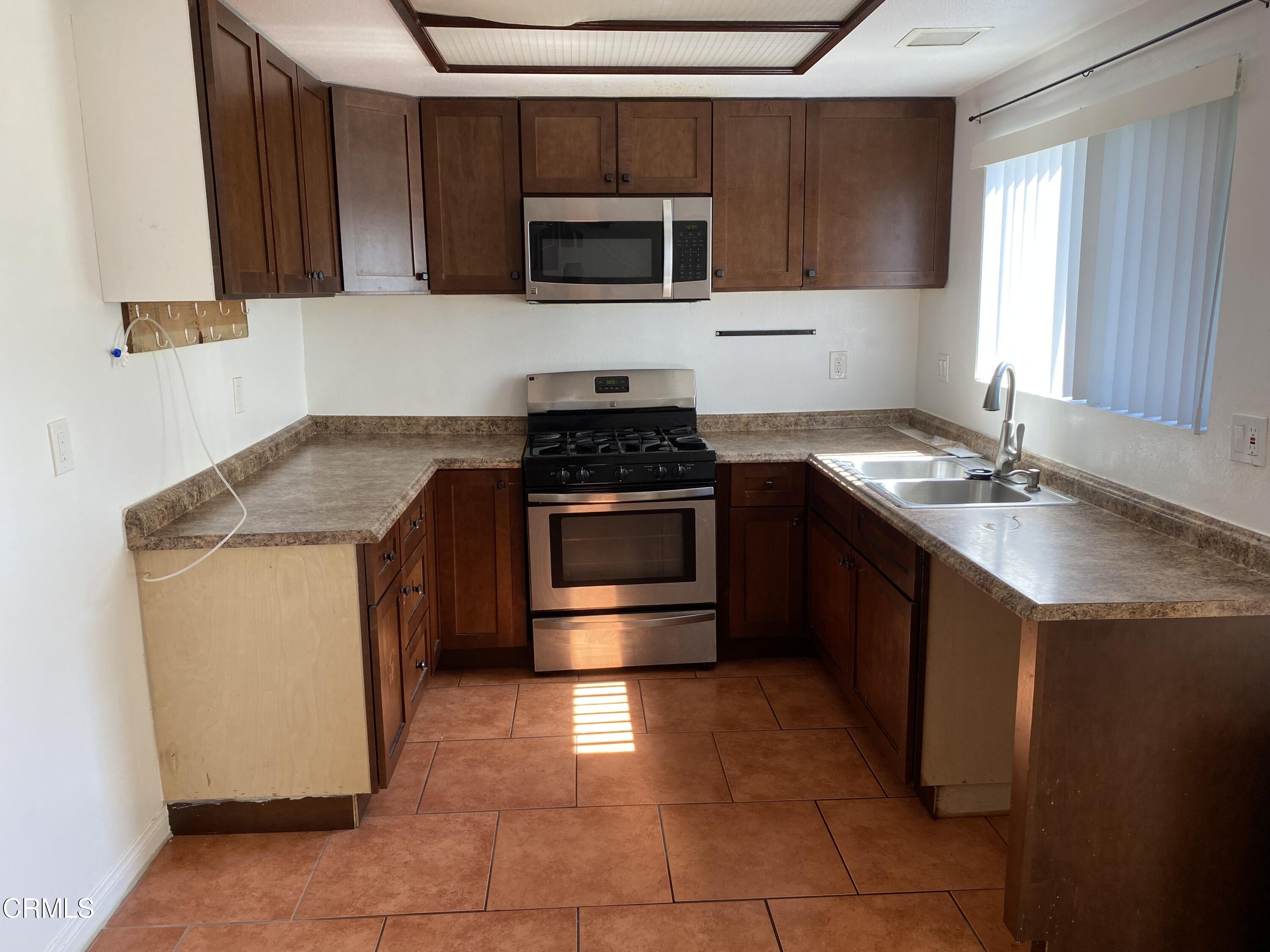 5305 Perkins Road Oxnard, CA 93033 - Photo 5 of 23 a kitchen with a stove and a microwave