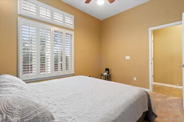 a bedroom with a large bed and a large window