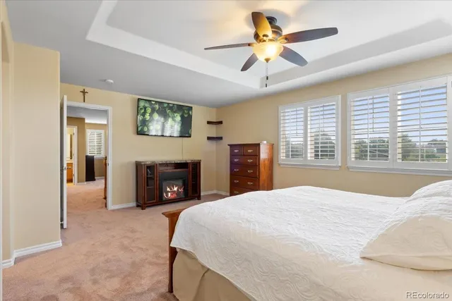 a bed room with a balcony a bed and a fireplace