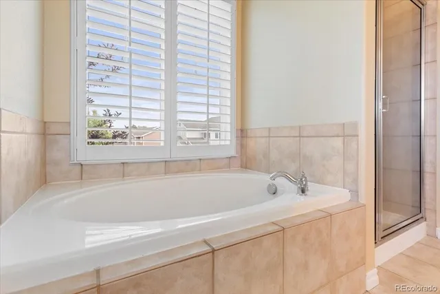 a bathroom with bathtub and window