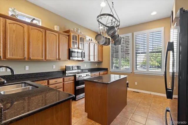 a kitchen with stainless steel appliances granite countertop a sink stove and cabinets