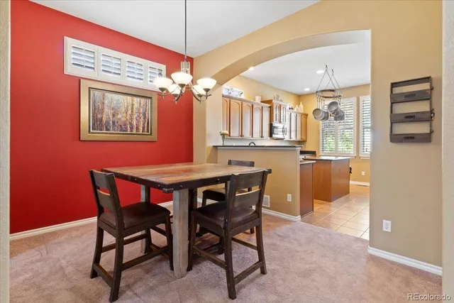 a dining room with a wooden table and chairs