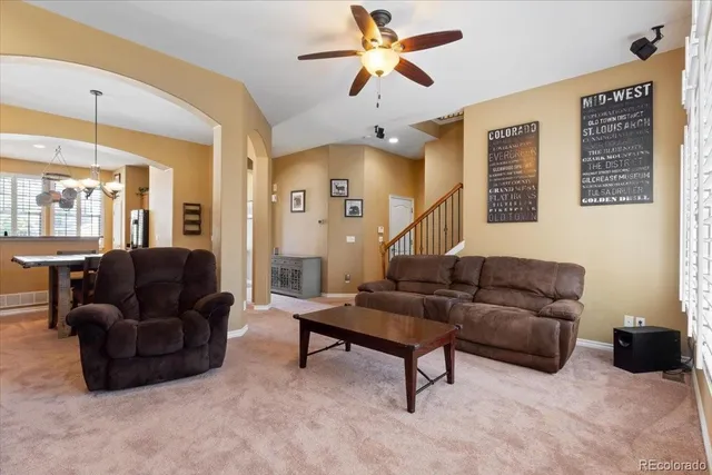 a living room with furniture and a chandelier