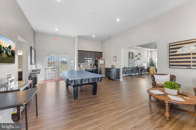 a living room with furniture wooden floor and a flat screen tv