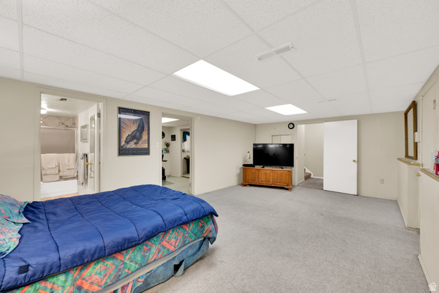 8029 Angel Street Sandy, UT 84070 - Photo 13 of 21 Carpeted interior space featuring neutral wall paint, a drop ceiling with integrated lighting, and white trim