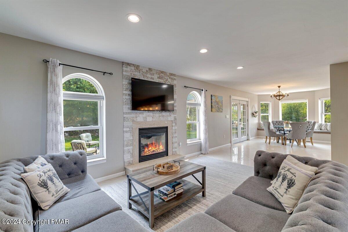 2175 Longview Drive Bushkill, PA 18324 - Photo 12 of 50 a living room with furniture a fireplace and a flat screen tv