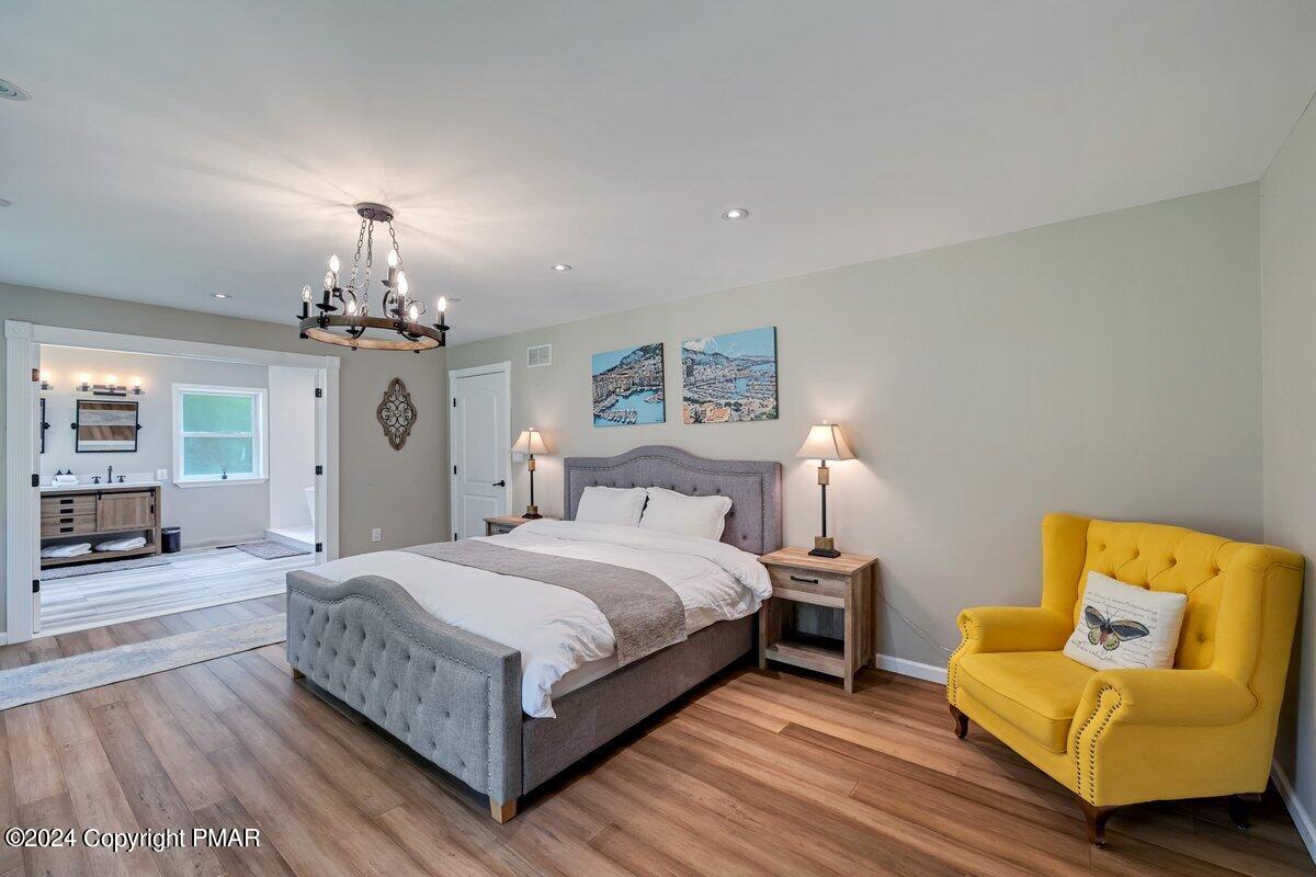 2175 Longview Drive Bushkill, PA 18324 - Photo 17 of 50 a bedroom with a bed couch chandelier and a window