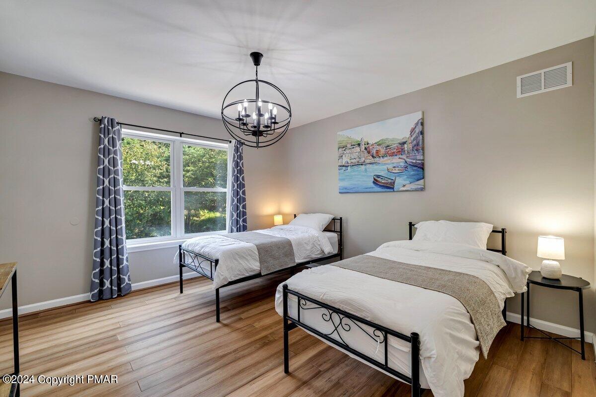 2175 Longview Drive Bushkill, PA 18324 - Photo 24 of 50 a spacious bedroom with two beds and a large window