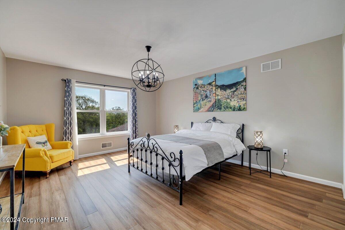 2175 Longview Drive Bushkill, PA 18324 - Photo 26 of 50 a bedroom with a bed and wooden floor