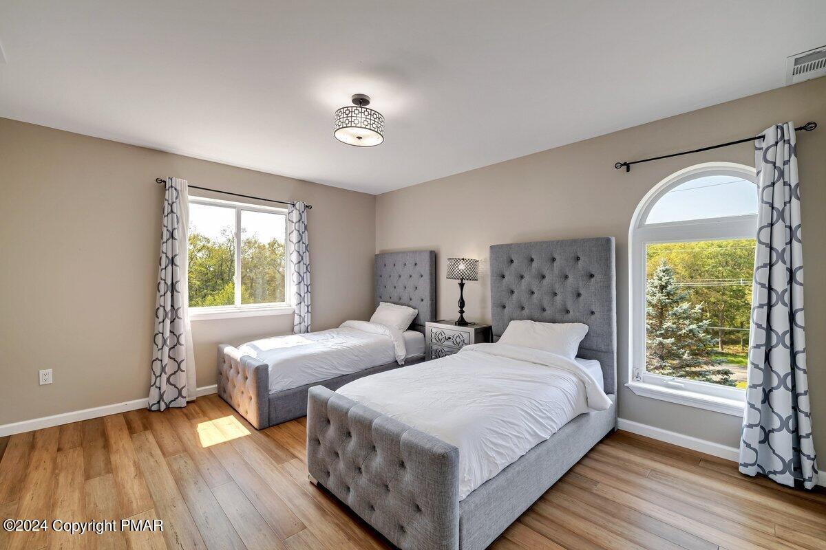 2175 Longview Drive Bushkill, PA 18324 - Photo 31 of 50 a bedroom with two beds and a large window