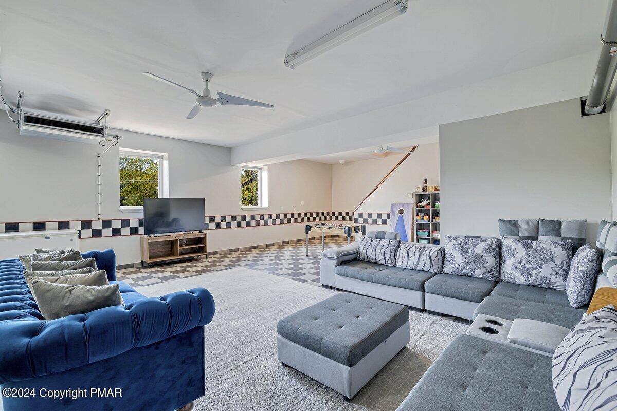 2175 Longview Drive Bushkill, PA 18324 - Photo 33 of 50 a living room with furniture and a wooden floor