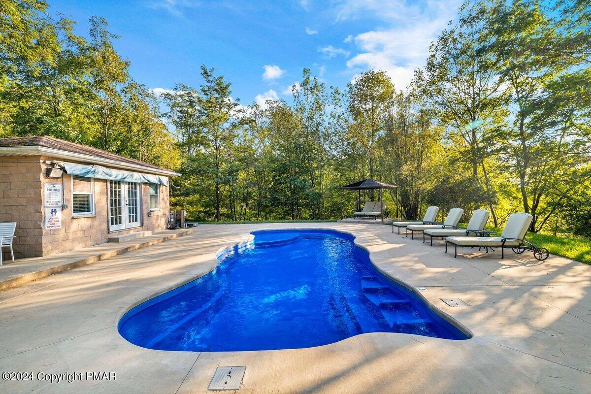2175 Longview Drive Bushkill, PA 18324 - Photo 37 of 50 a swimming pool with outdoor seating and yard