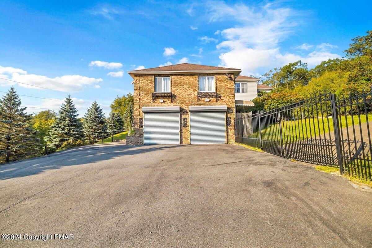 2175 Longview Drive Bushkill, PA 18324 - Photo 42 of 50 a view of a white house with a outdoor space and balcony