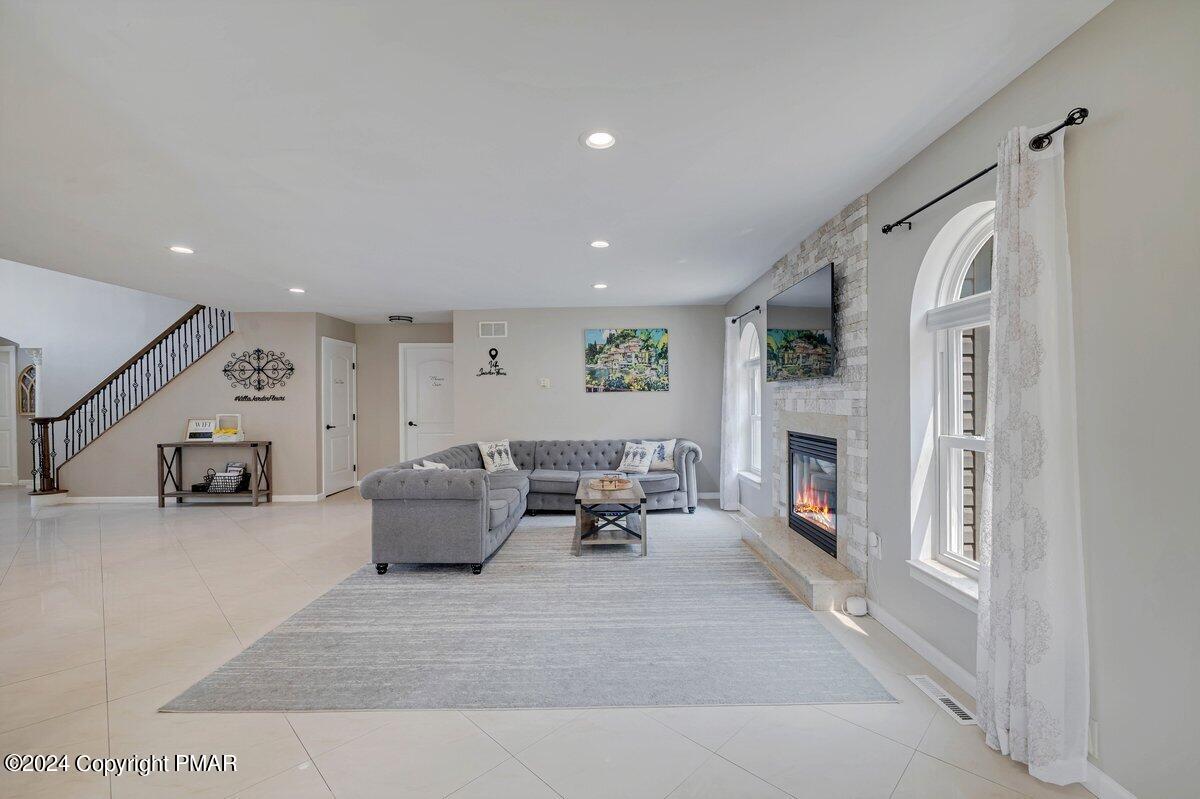 2175 Longview Drive Bushkill, PA 18324 - Photo 8 of 50 a living room with furniture a fireplace and a flat screen tv