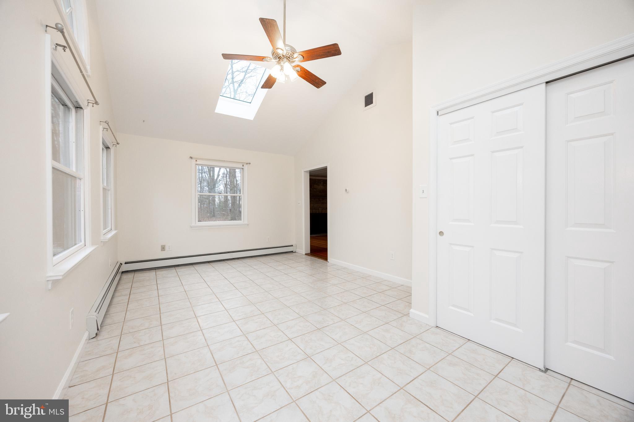 5816 Upper Ridge Road Pennsburg, PA 18073 - Photo 14 of 71 an empty room with windows and ceiling fan