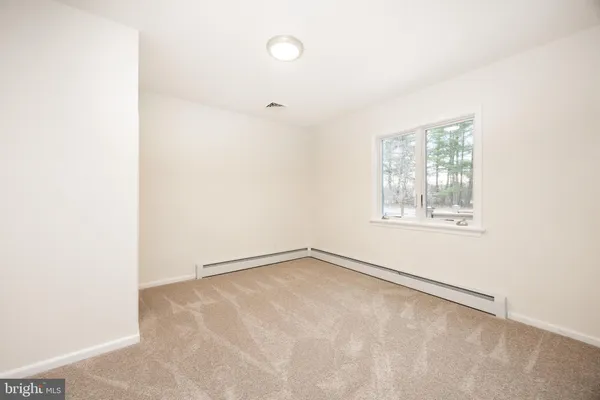 a view of a room with a ceiling fan and hardwood floor